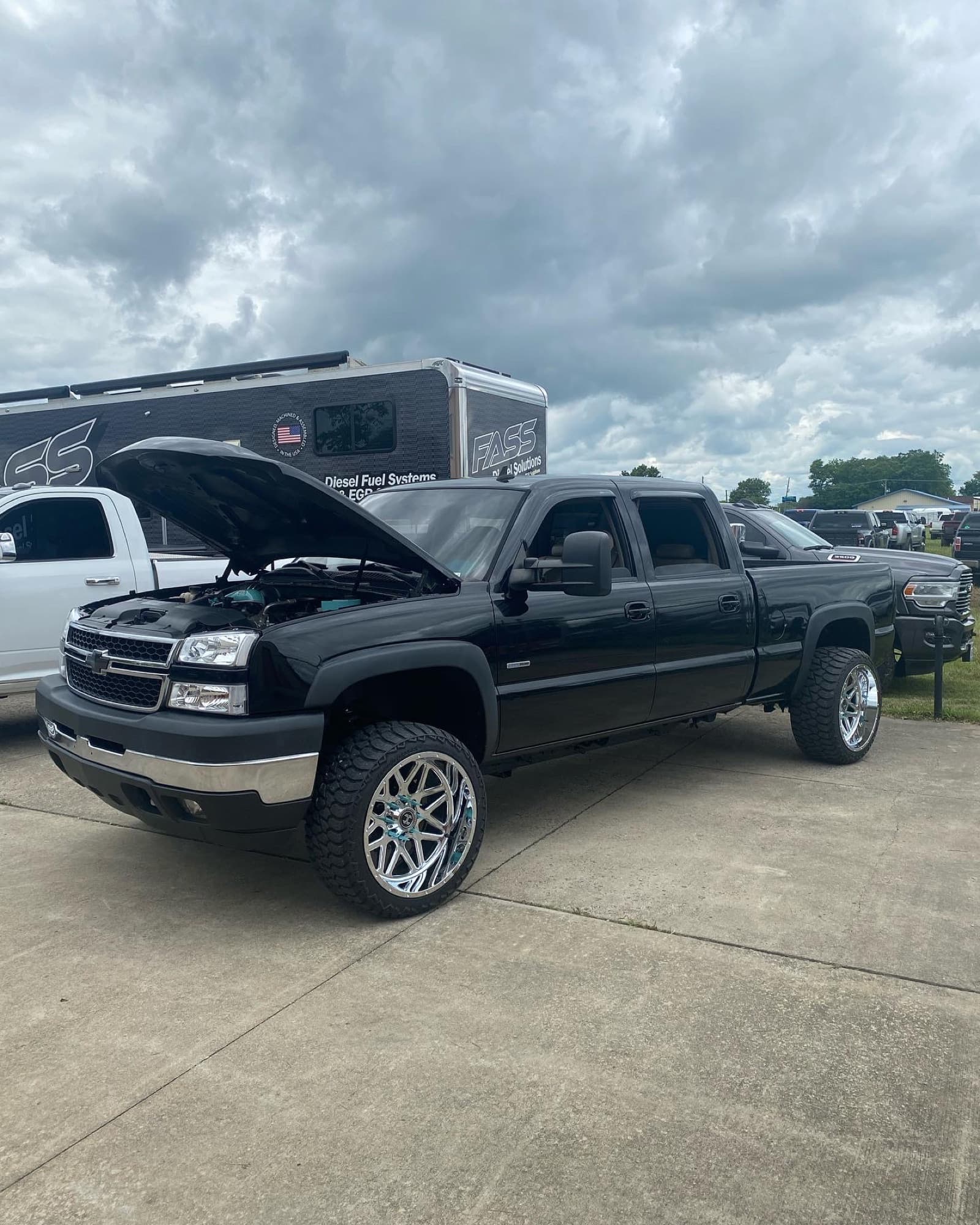 Duramax build with the hood up at a truck show